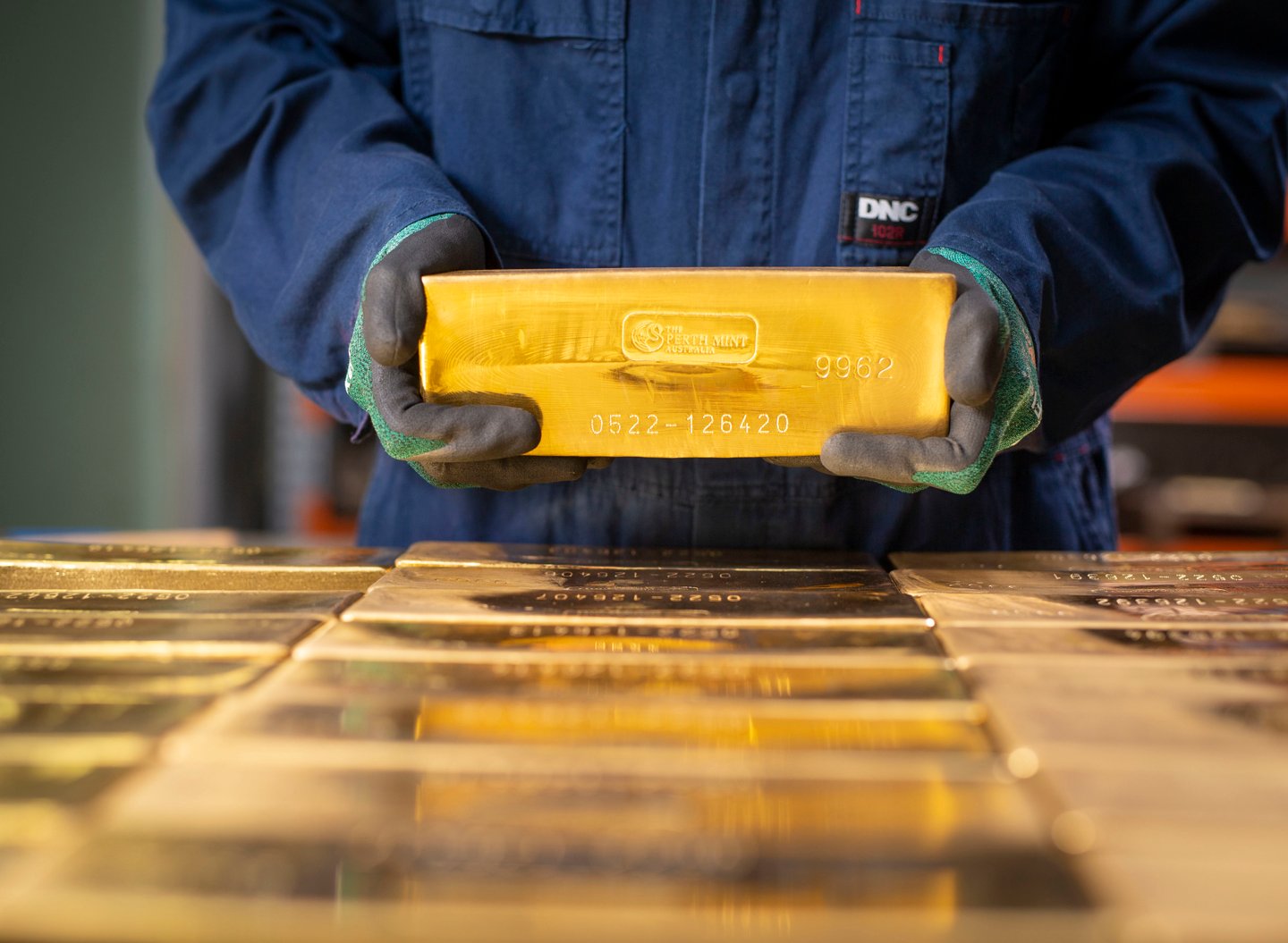 Perth Mint gold bar held by Perth Mint refinery worker